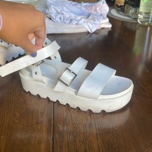 White studded platform sandals.